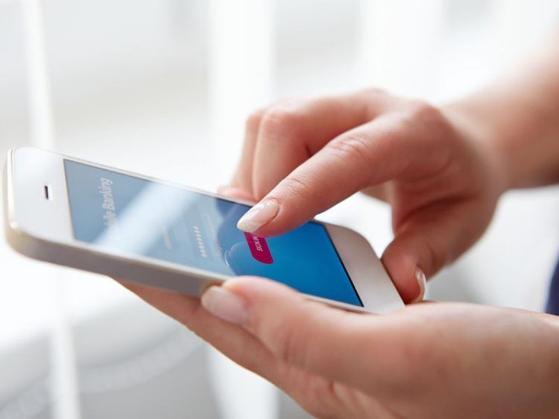 Female hands using mobile banking on smartphone
